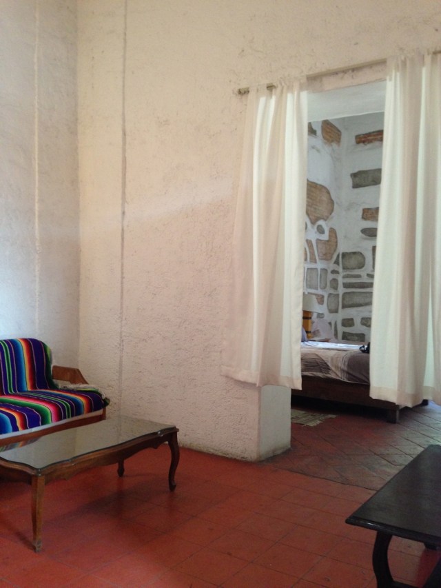 Living room area looking into bedroom