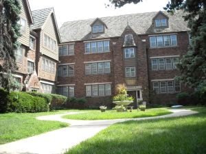 Brick apartment building with courtyard.