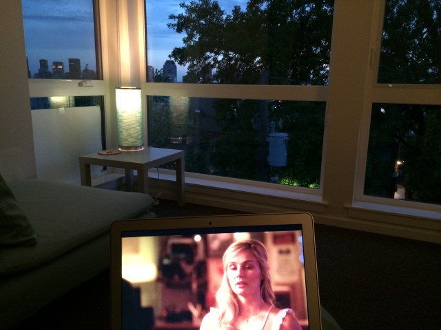 Watching shows on my laptop while the sun sets out my window.