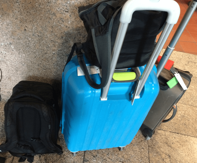 Two rolling bags, two small backpacks.