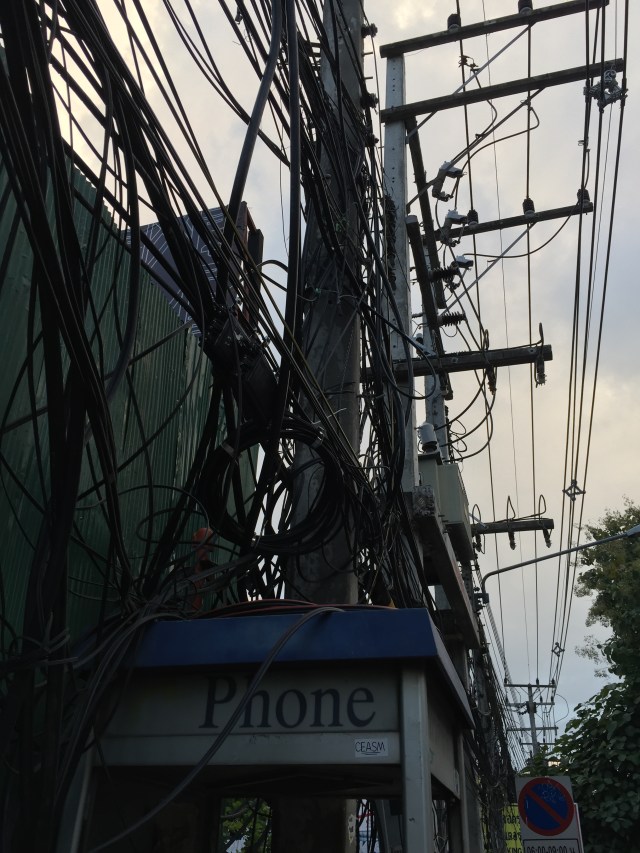 Telephone polls with lots of wires.