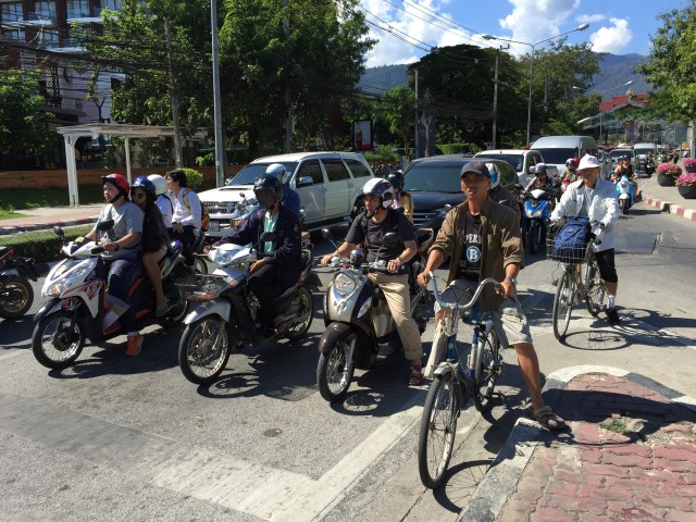 Scooters, bicycles, and cars.