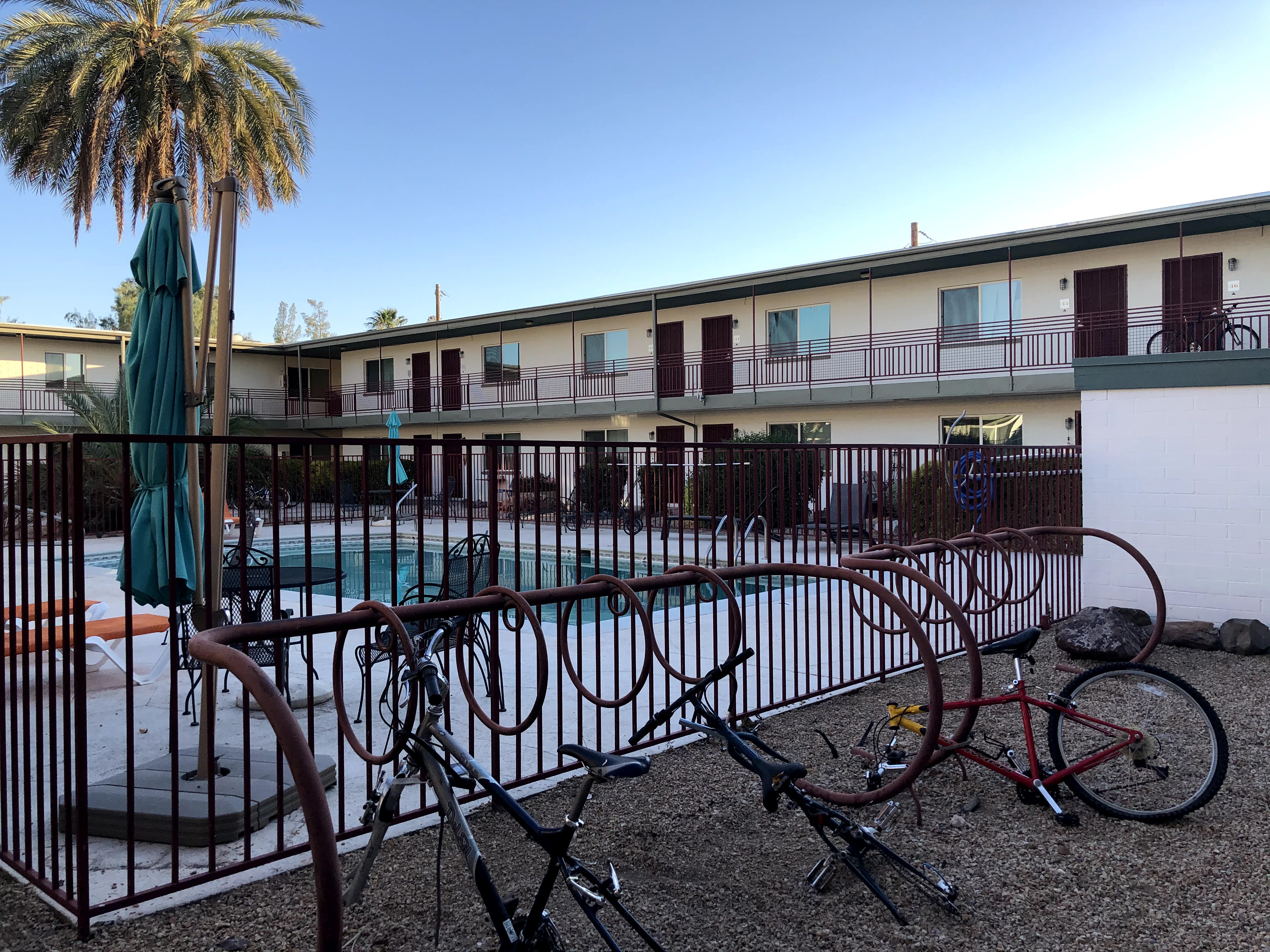 a bike rack with some bikes stripped of wheels and parts
