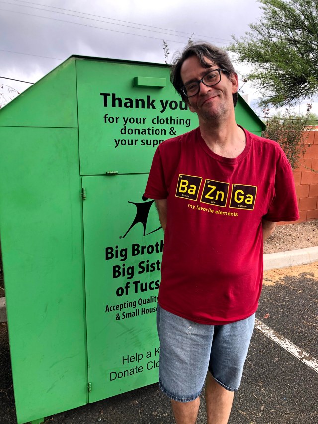 Big Brothers Big Sisters of Tucson clothing bin with James standing in front.